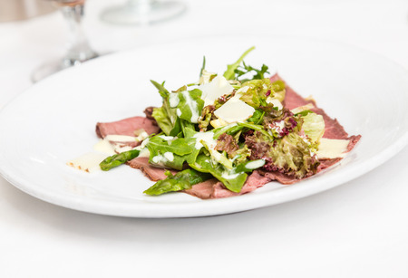 Fresh carpaccio with shaved parmesan and arugula leavesの写真素材