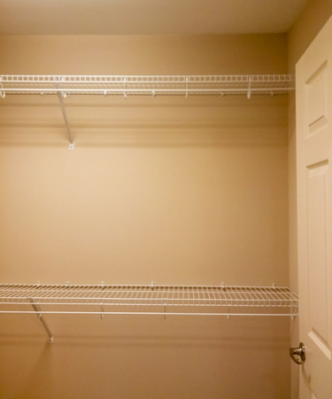 Empty wire shelves in a new closetの写真素材