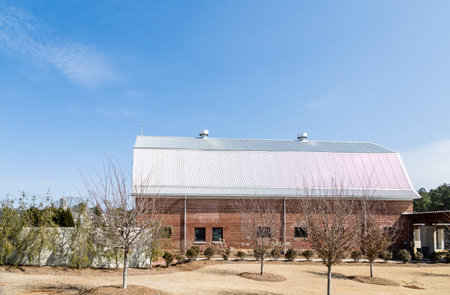 A red brick dairy barn at a catholic monasteryの写真素材