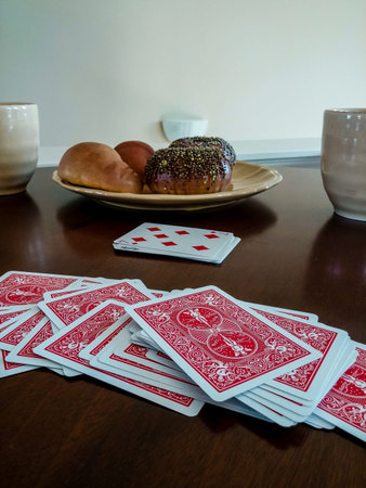 Deck of playing cards on table with plate of fresh bagels