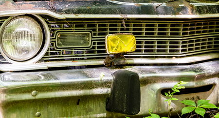 Yellow fog light on an old abandoned carの写真素材