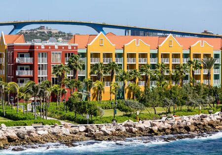 Brightly colored resort hotels on the coast of Curacaoの写真素材