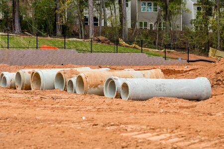 Drain and sewer pipes in dirt at a residential construction siteの写真素材