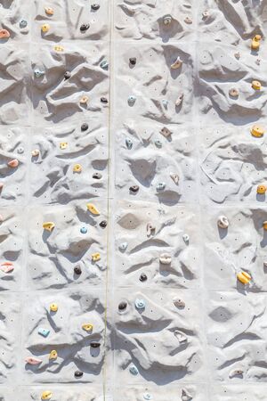 A rock climbing wall on a cruise ship with bells at topの写真素材
