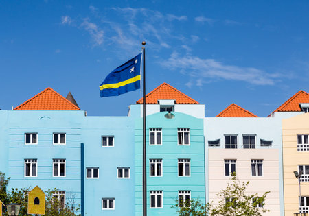 Curacao Flag by colorful buildings under nice skies