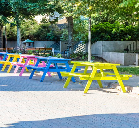 A line of colorful wooden picnic tables in the street in Charlottetown, Canada