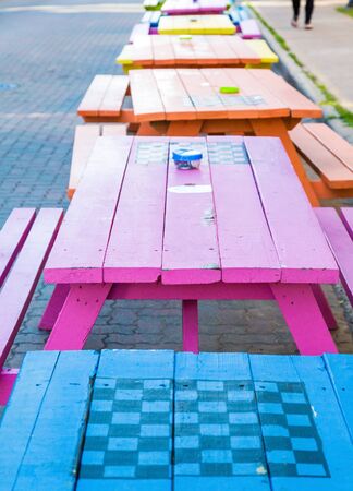 A line of colorful wooden picnic tables in the street in Charlottetown, Canadaの写真素材