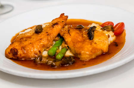 Veal Marsala on Asparagus with sauceの写真素材