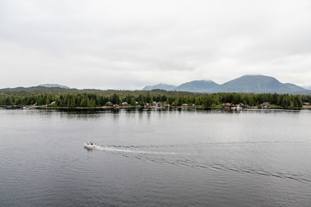 Fishing boats heading out in the early morning light of Alaskaの写真素材