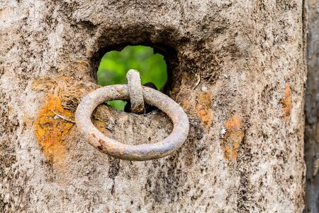 Old rusty chain on a weathered wooden postの写真素材
