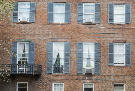 Black shutters on an old red brick building