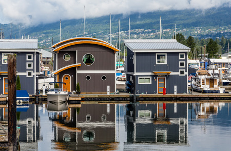 Cottages in Marina Reflected in Waterの写真素材