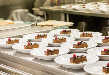 Chocolate desserts plated in commercial kitchenの写真素材