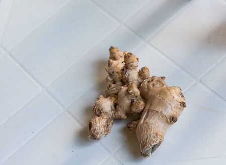 Raw Hands of Ginger on White Tableの写真素材