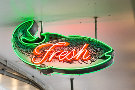 Neon Fresh Fish Sign hanging from ceilingの写真素材