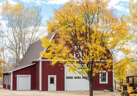 An old red barn in an autumn landscapeの写真素材