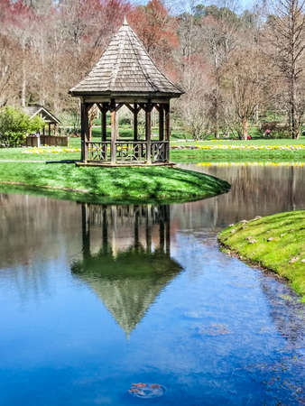 Wood Gazebo on Shore of Lake with Reflectionの写真素材