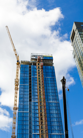 Yellow Crane and Elevator on New Blue Tower in Seattleの写真素材