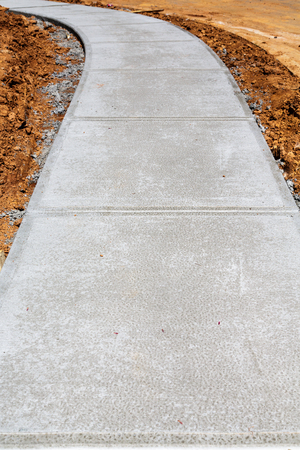 Newly Poured Concrete Sidewalk at Residential Construction Siteの写真素材