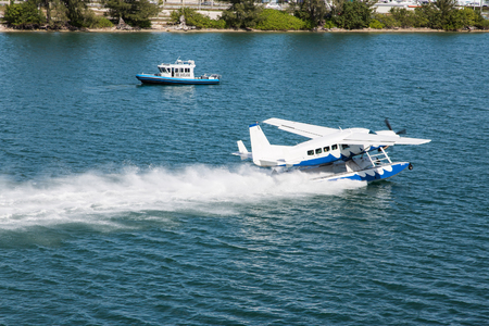 Float Plane Past Police Boat in Miamiの写真素材
