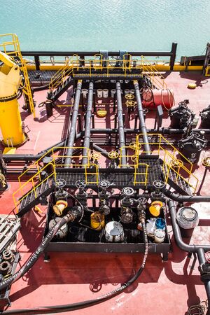 Pipes and valves on an industrial oil and fueling bargeの写真素材