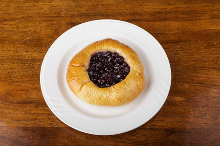 Blueberry Pastry on White Plate and Wood Tableの写真素材