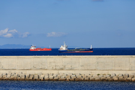 Tanker beyond the seawall in Barcelona harborの写真素材