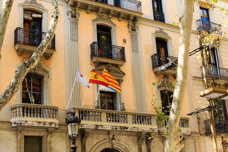 Three Flags on Old Barcelona Apartment Buildingの写真素材
