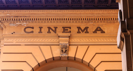 A Sign for Old Cinema on Stone Arch in Florenceの写真素材