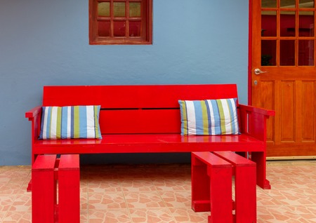 Colorful Cushions on Red Wood Benchの写真素材