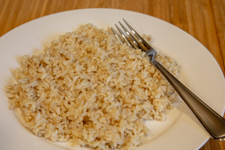 Brown Rice on White Plateの写真素材
