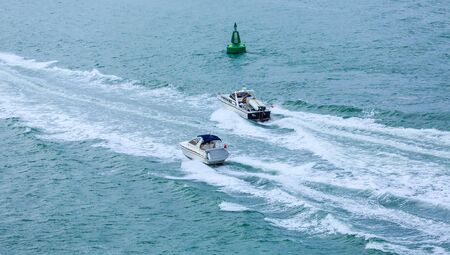 Two Boats in Wake Past Channel Markerのeditorial素材