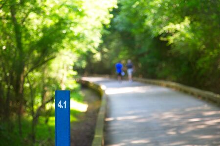Mile Marker with Couple Walking in Backgroundの写真素材