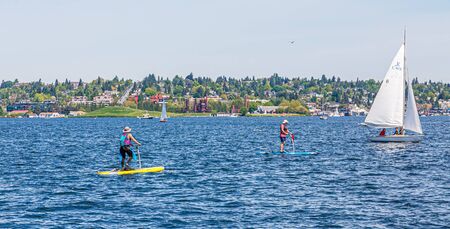 Two Paddle Boards and Sailboatのeditorial素材