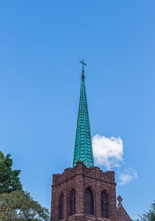 Old Bell Tower and Green Steeple of an Old Stone Churchの写真素材