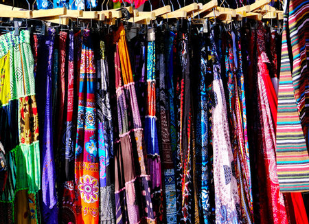 Rack of Colorful Dresses Hanging in a Market