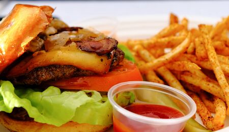 Gourmet Cheeseburger with French Fries and Ketchupの写真素材