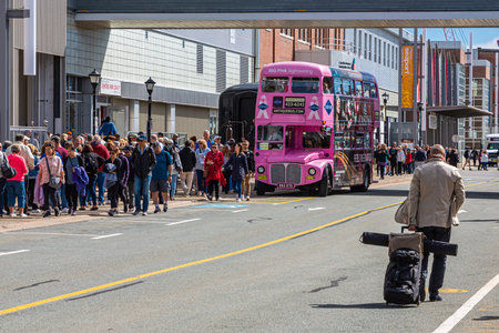 Tourists Queuing for the Pink Bus