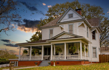An old farmhouse with house plants on the front porch