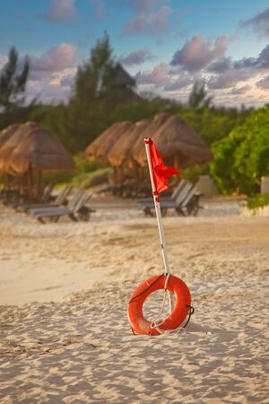 Life Ring and Warning Flag on Tropical Beachの写真素材
