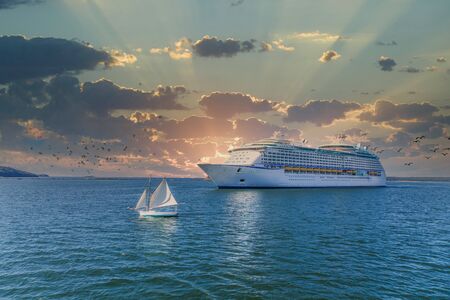Sailboat and Cruise Ship at Sunsetの写真素材