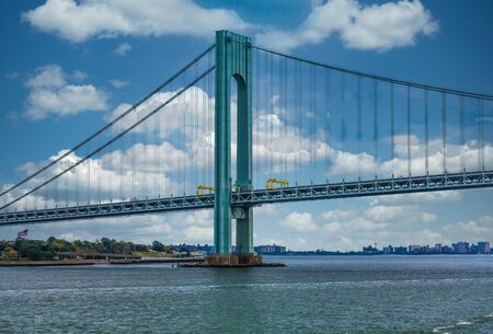The Verrazano Bridge under blue skies on a foggy day in New York Cityの写真素材