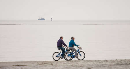 Retired Couple Riding on Beachのeditorial素材