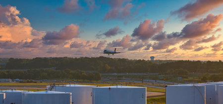 Plane Descending Over Tanks at Dusk