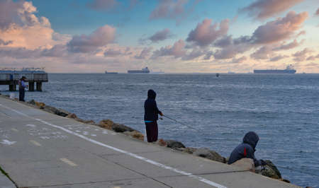 Fishing from Pier at Duskのeditorial素材