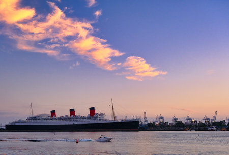 Boat Past Queen Mary at Sunset