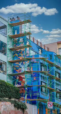 Green Scaffolding on Blue Buildingのeditorial素材