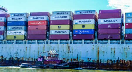 SAVANNAH, GEORGIA - October 19, 2021: Freighters now carry most of the world's cargo and the largest container ships can carry over 21,000 units of freight.の写真素材