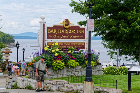 Man by Bar Harbor Inn Sign