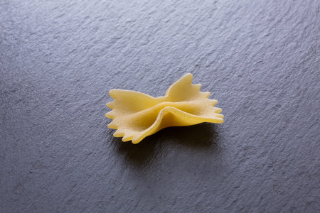 farfalle pasta on a black background. selective focus